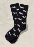 Black socks with white zebra pattern on a beige background