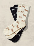 Three pairs of socks with animal prints on a beige background