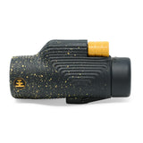 Black and gold monocular on a white background