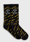 Black cotton socks with yellow lightning bolt design and white logo, suitable for everyday wear.