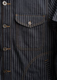 Dark wash cotton shirt with pinstripes, brown stitching, buttons, and a single chest pocket.