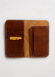 Cognac vegetable-tanned leather wallet with card slots, shown open against a white background.