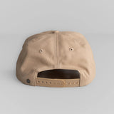 Beige canvas hat shown from the back with tan adjustable plastic snap closure for a secure fit.