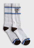 Crew socks in white cotton with brown toes, blue stripes near the top, and bold black text at the cuff.