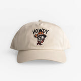 Beige adjustable hat with embroidered cartoon cowboy face and text, cotton material, suitable for casual western style wear.