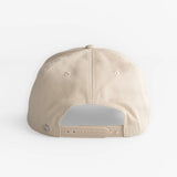 Beige canvas snapback hat shown from the back, featuring an adjustable closure for a comfortable fit.