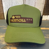 Green vintage-style trucker cap with moisture-wicking band for comfort during all-day wear.