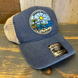 Blue Hermosa Beach California trucker hat with coastal patch on rustic wood surface