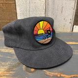 Vintage black cotton hat with a sunset patch, designed for field trips and casual outdoor wear.