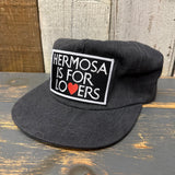 Black washed cotton hat with a red heart patch, designed for casual or everyday use.