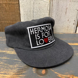 Washed cotton field trip hat in neutral tones, features a patch with HERMOSA IS FOR LOVERS and a red heart-shaped V.