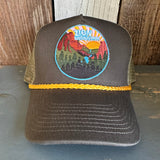 Five-panel cap with cotton twill front, mesh back, loden green color, and gold braid; ideal for outdoor use.