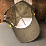 Inside-out 5-panel cap with loden front, gold braid, and mesh back displayed on wooden surface.