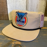 Khaki nylon-cotton hat with volleyball patch and black rope detail, displayed on a wooden surface.