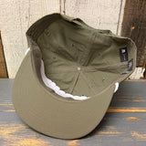 Army green and white surf rope cap, turned inside out, displayed on a wooden surface.
