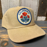 Khaki corduroy baseball cap on a wooden surface, displaying its textured fabric and casual style.