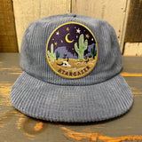 Slate blue corduroy field trip hat with patch detail and adjustable strap. Ideal for outdoor or casual wear.