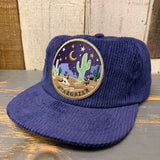Navy corduroy field trip hat with a desert patch showing cacti, stars, and a moon. Suitable for outdoor casual wear.