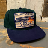 Dark green and navy low profile cap with embroidered pier patch; casual cotton hat for everyday wear.