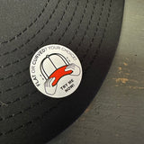 Black hat with a sticker showing adjustable flat or curved brim option