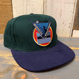 Dark green and navy volleyball cap with mountain patch, suitable for outdoor sports or casual wear.