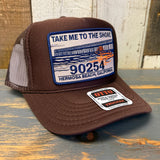 Brown mesh trucker hat with a front patch displaying 90254 and a graphic of a pier. Ideal for casual, outdoor wear.