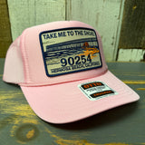 Pink high crown trucker hat with mesh back, featuring a patch with 90254 and a pier graphic. Suitable for casual wear.