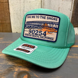 Cactus green trucker hat with mesh panels and adjustable snap closure; ideal for sun protection.