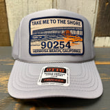 Grey high-crown trucker hat with embroidered 90254 patch and pier graphic, mesh back, suitable for casual outdoor wear.