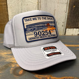 Gray trucker hat with curved brim and high crown, featuring a patch that reads TAKE ME TO THE SHORE 90254.