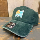 Dark green six-panel cotton dad hat with LIFEGUARD TOWER text, placed on a wooden surface.