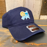 Navy blue cotton dad hat with lifeguard tower design, displayed on a wooden surface. Ideal for sunny outdoor wear.