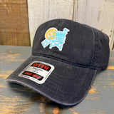 Charcoal grey 6-panel cotton dad hat with lifeguard tower patch, displayed on rustic wooden surface.