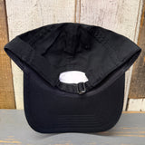 Black cotton dad hat, lifeguard tower design, displayed upside down on rustic wood surface.