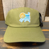 Desert green cotton mini dad hat with lifeguard tower design, displayed on a wooden surface.