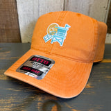 Pumpkin orange cap with a logo on a wooden surface.