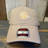 Khaki cap with a Hb logo and brand label on a wooden surface.