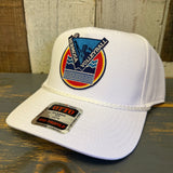 White cap with a colorful logo and 'OTTO' label on a wooden surface.