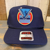Navy blue cap with volleyball logo and 'Otto' label on a wooden surface