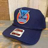 Navy blue cap with a colorful Volleyball Hermosa logo on a wooden surface