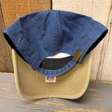 Navy and khaki dad hat with cotton lining, lifeguard tower design, shown upside down on wooden surface.