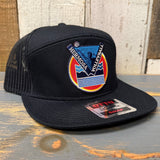 Black cap with a colorful "Hermosa Volleyball" patch on a wooden surface