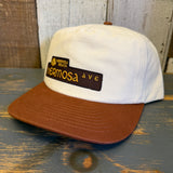 White and brown cap with 'Hermosa Beach Hermosa Ave' logo on a wooden surface.