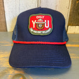 navy blue cap with a red and green patch with smokey the bear and text that says only you can prevent forest fires on a wooden surface
