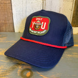 navy blue cap with a red and green patch with smokey the bear and text that says only you can prevent forest fires on a wooden surface
