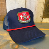 navy blue cap with a red and green patch with smokey the bear and text that says only you can prevent forest fires on a wooden surface