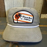 Beige corduroy cap with Hermosa Beach California patch on a wooden surface