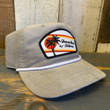 Beige corduroy cap with Hermosa Beach California patch on a wooden surface