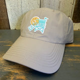 beige cap with a beach chair and sun design on a wooden surface