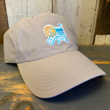 beige cap with a beach chair and sun design on a wooden surface
